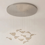 Wide round brushed canopy with a few small fixings and amber glass leaves hung on long drops, from Clérachic.