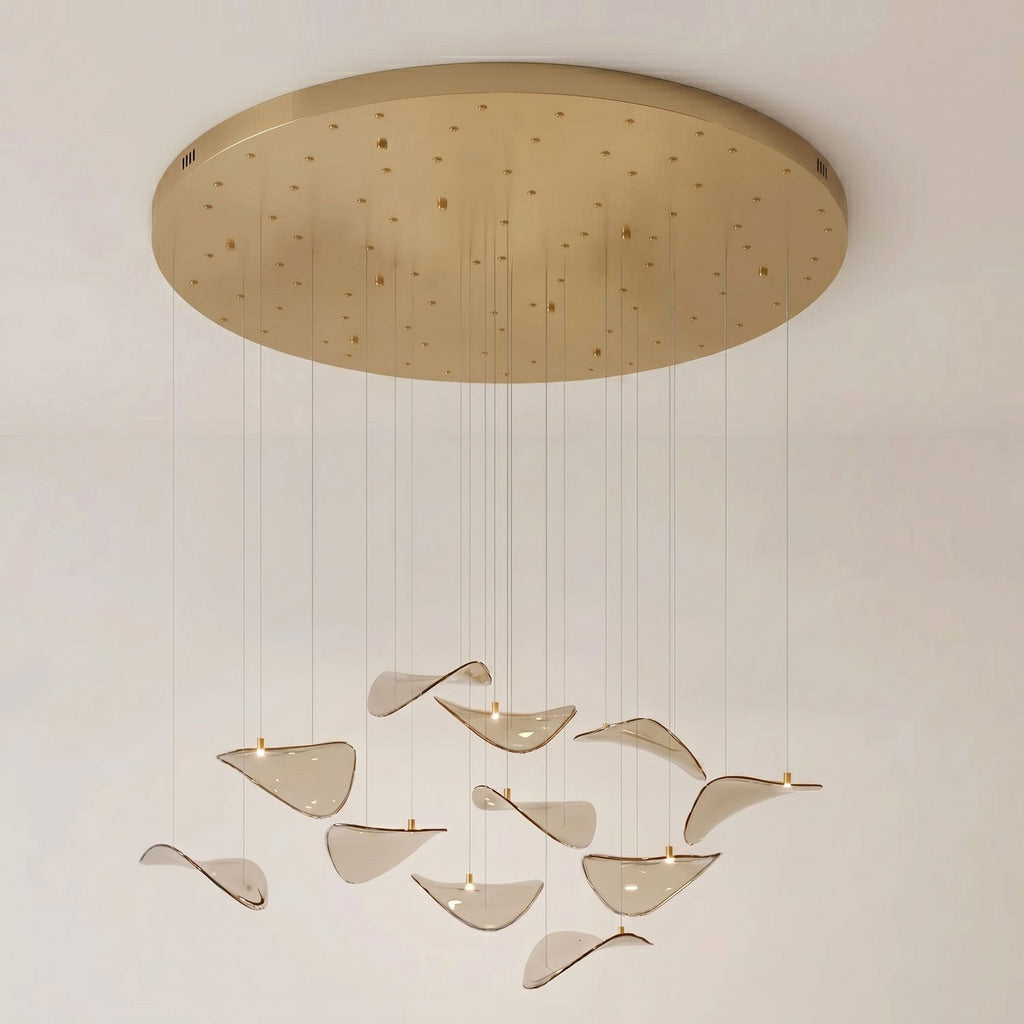 Round gold canopy studded with cable points, with a loose group of amber glass leaves hanging below, from Clérachic.