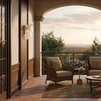 A Clérachic wall light on a panelled wall beside an arched terrace opening, with wicker armchairs and a view across hills.