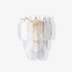 Clérachic wall light, unlit, on a pale background, with a soft shadow of the glass leaves falling at its side.