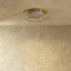 Clérachic ribbed-glass drum ceiling light in a gold finish, shown flush-mounted on a plaster ceiling, unlit.