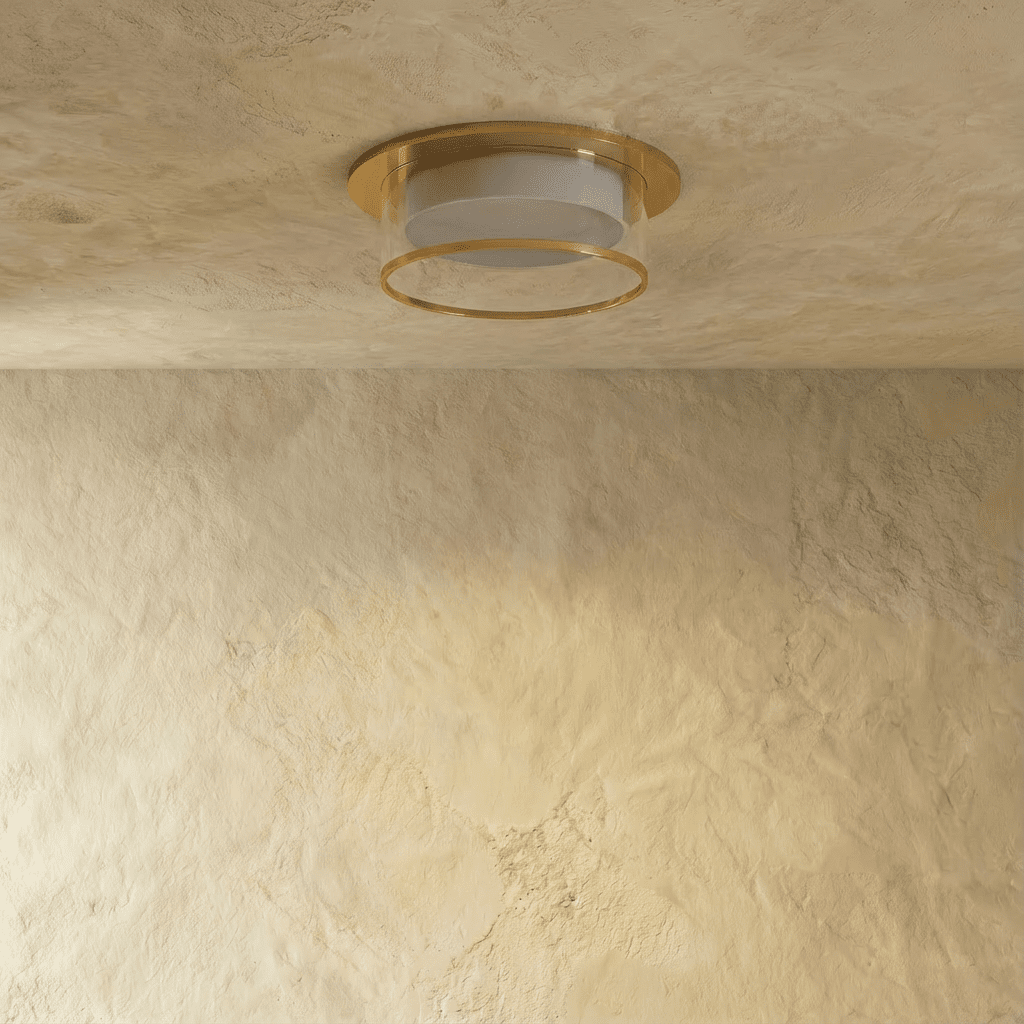 Clérachic ribbed-glass drum ceiling light in a gold finish, shown flush-mounted on a plaster ceiling, unlit.