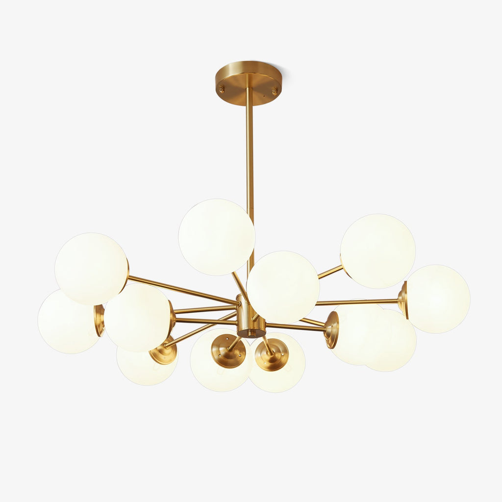 Brass-framed chandelier with a cluster of frosted white glass orbs, this Clérachic pendant light shown on a plain white backdrop.