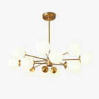 Brass-framed chandelier with a cluster of frosted white glass orbs, this Clérachic pendant light shown on a plain white backdrop.