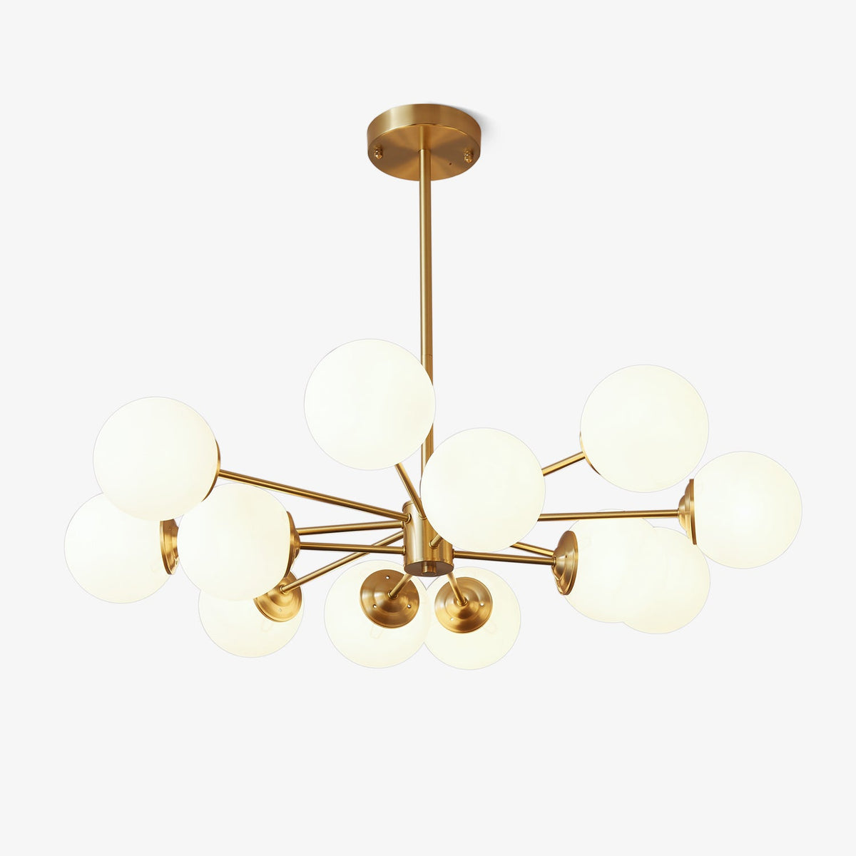 Brass-framed chandelier with a cluster of frosted white glass orbs, this Clérachic pendant light shown on a plain white backdrop.