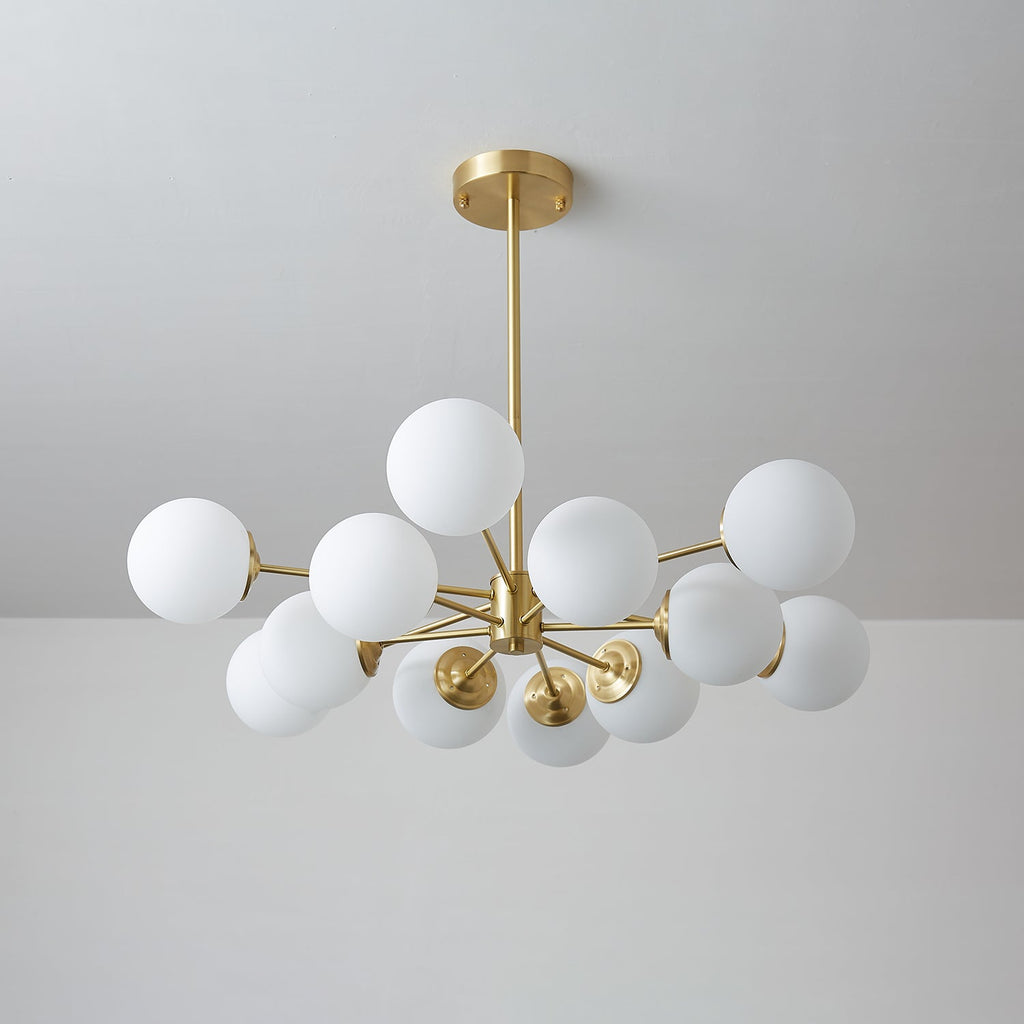 Cool-toned view of this Clérachic chandelier switched off, its white orbs clustered around a brass hub.