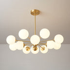 Clérachic chandelier with warm lit orbs on long brass arms, shown at a wide angle against a taupe wall.