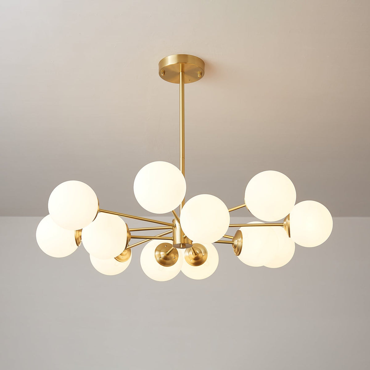 Brass chandelier with lit frosted orbs on slender arms, a Clérachic light in a symmetrical, open layout.