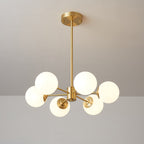 Compact Clérachic chandelier with five large lit frosted orbs, a brass hub and a short drop rod.