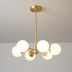A Clérachic chandelier with six lit orbs on short brass arms, seen from a low angle with its canopy above.