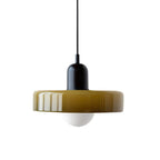 Olive-green glass disc with a black cap and black cord and a frosted globe below, on a white backdrop, from Clérachic.
