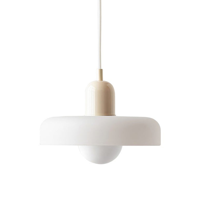 A white disc pendant with a beige cap and a white cord, with a frosted globe below it, on white, from Clérachic.