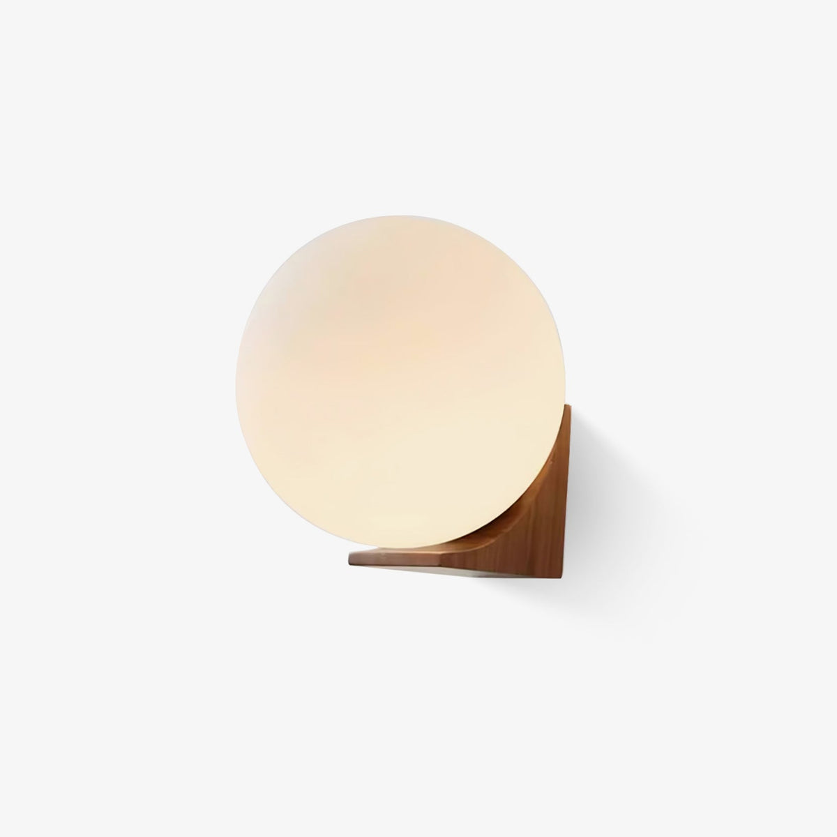 Frosted glass orb on a walnut wooden bracket, this Clérachic wall light shown unlit against a plain white background.