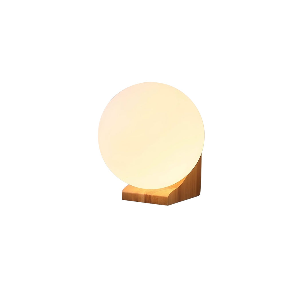 Side view of this Clérachic glass orb wall light on white, with the glowing sphere seated on a pale wooden bracket.
