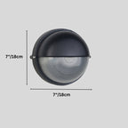 Clérachic round black wall lamp with a domed hood and ribbed glass, on a grey backdrop with its 18 cm diameter marked.