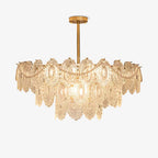 Tiered Clérachic chandelier with embossed clear glass panels, looped pearl strands and a gold rod, on a plain white background.