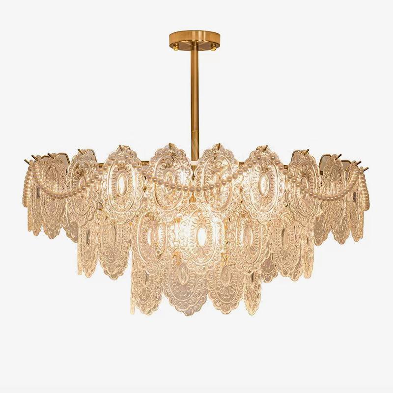 Two-tier Clérachic glass chandelier with pearl swags and a short gold rod, on a plain white backdrop.