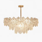 This Clérachic chandelier with tiers of patterned glass and pearl beads, seen straight on against a white background.