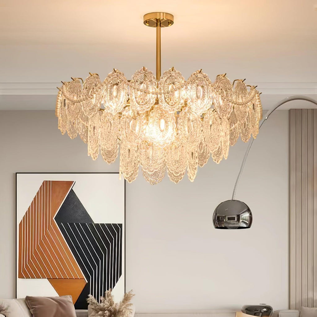 Clérachic glass chandelier in a living room with a geometric artwork and an arched chrome floor lamp.