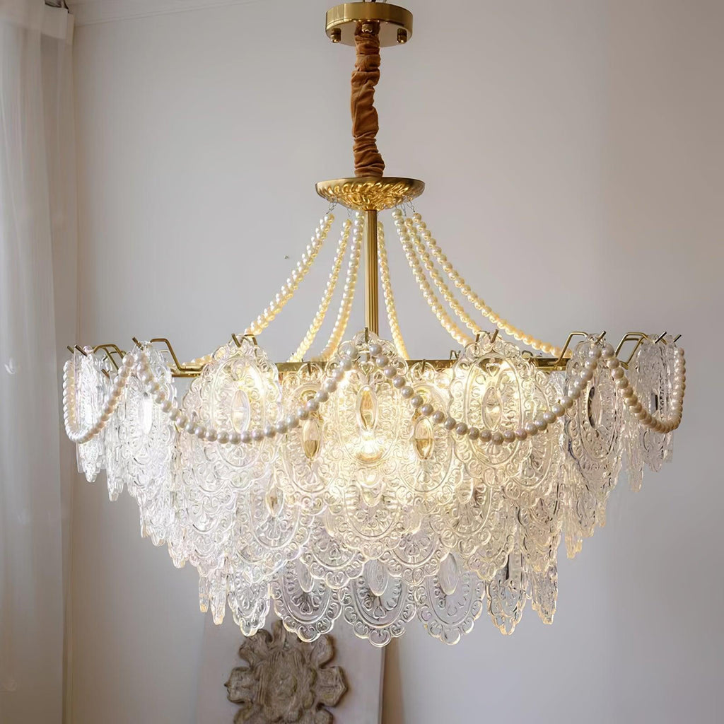 Close view of the Clérachic pendant, with pearl strands over lace-patterned glass panels and a brown fabric-wrapped chain at the top.