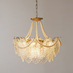 A smaller view of the Clérachic pendant, with fewer glass panels and gold wire tips along its rim, lit against a plain grey wall.