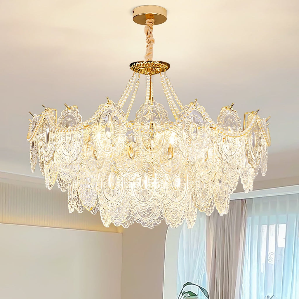Looking up at the lit Clérachic pendant in a bright room, with embossed clear glass panels and a wrapped chain below a gold ceiling plate.