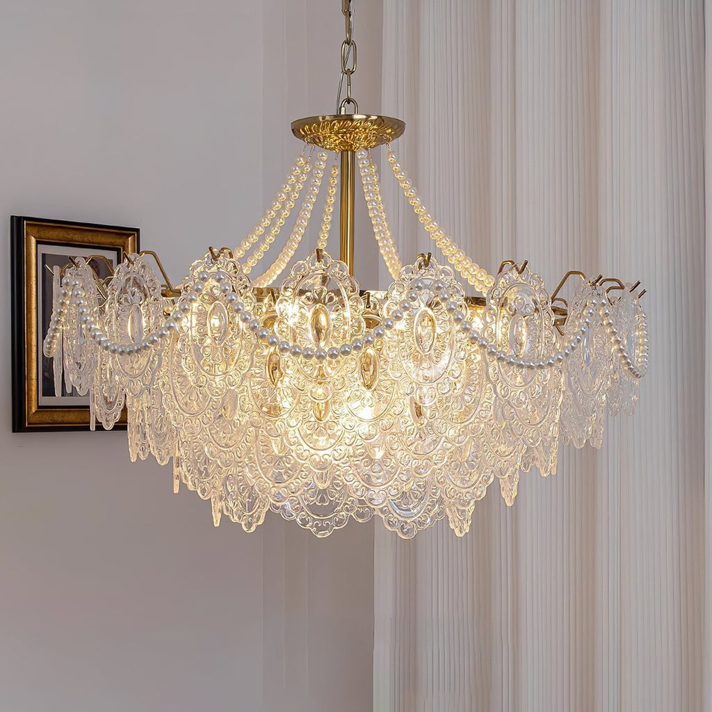A Clérachic pendant with wide glass petals and pearl swags hanging beside a gilt-framed portrait and a pleated curtain.