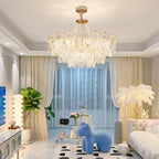 This Clérachic pendant light hangs in a bright living room with cream drapes, a blue sculpted animal seat, a green plant and a white sofa.