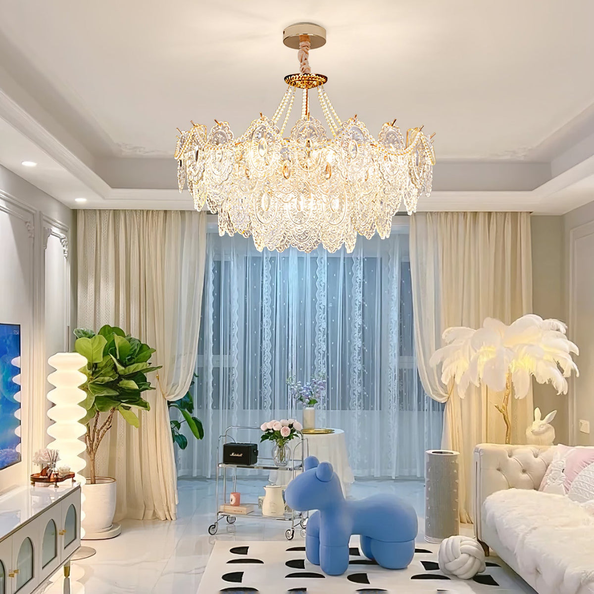 This Clérachic pendant light hangs in a bright living room with cream drapes, a blue sculpted animal seat, a green plant and a white sofa.