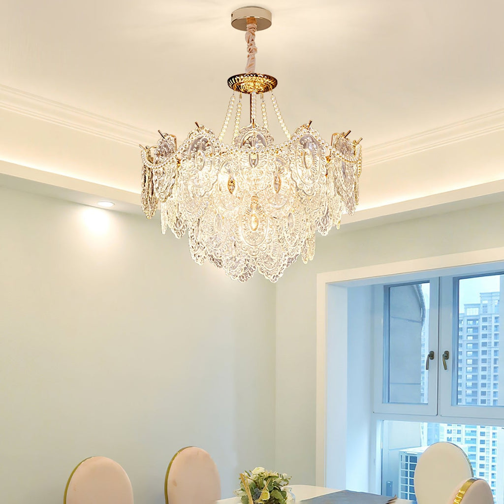 Lit Clérachic pendant in a dining room with white cornice lighting, pale green walls, a window and white chairs at the table below.