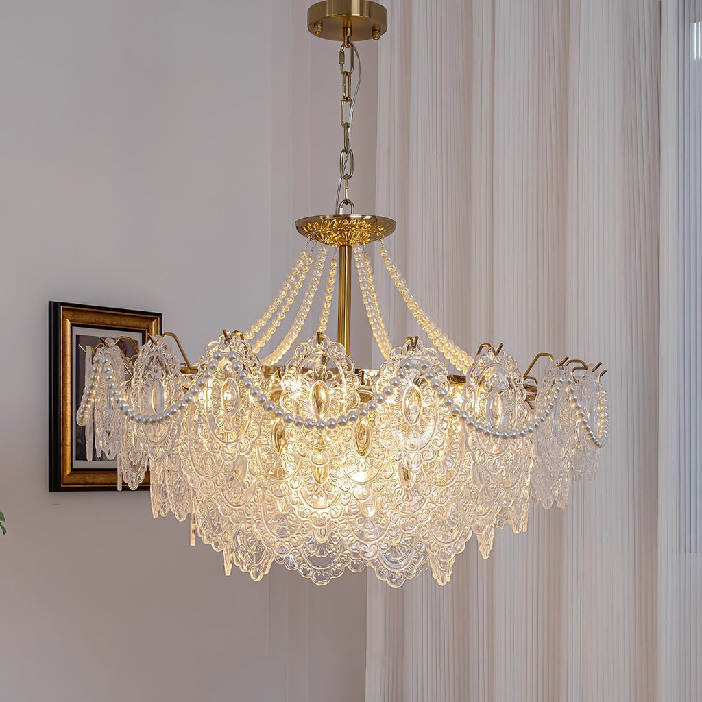This Clérachic pendant light hangs beside a gilt-framed portrait, with lace-patterned glass panels and pearl swags lit from within.