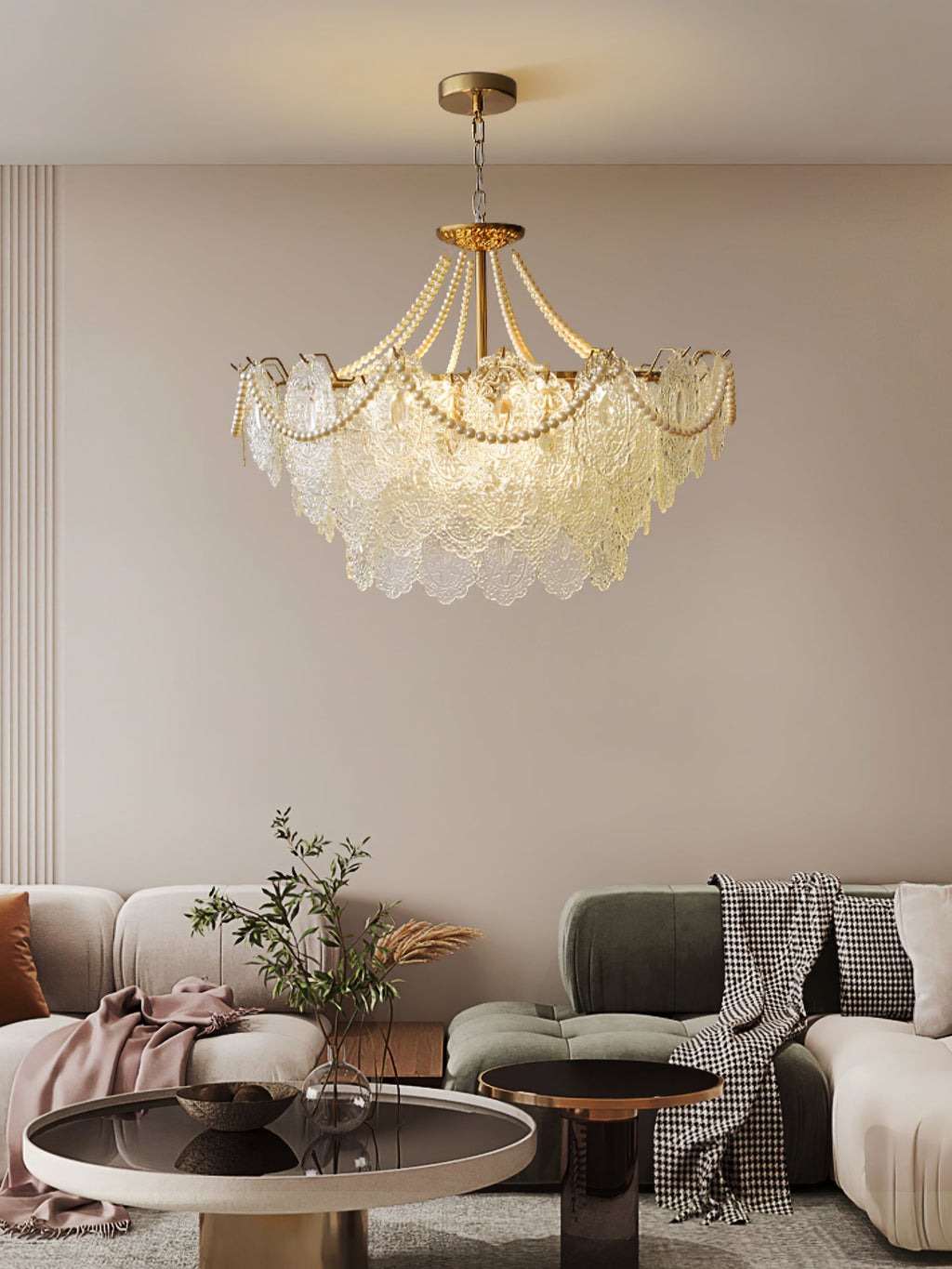 Seen from a distance, the Clérachic pendant hangs in a living room with a cream curved sofa, a green sofa and two round tables.