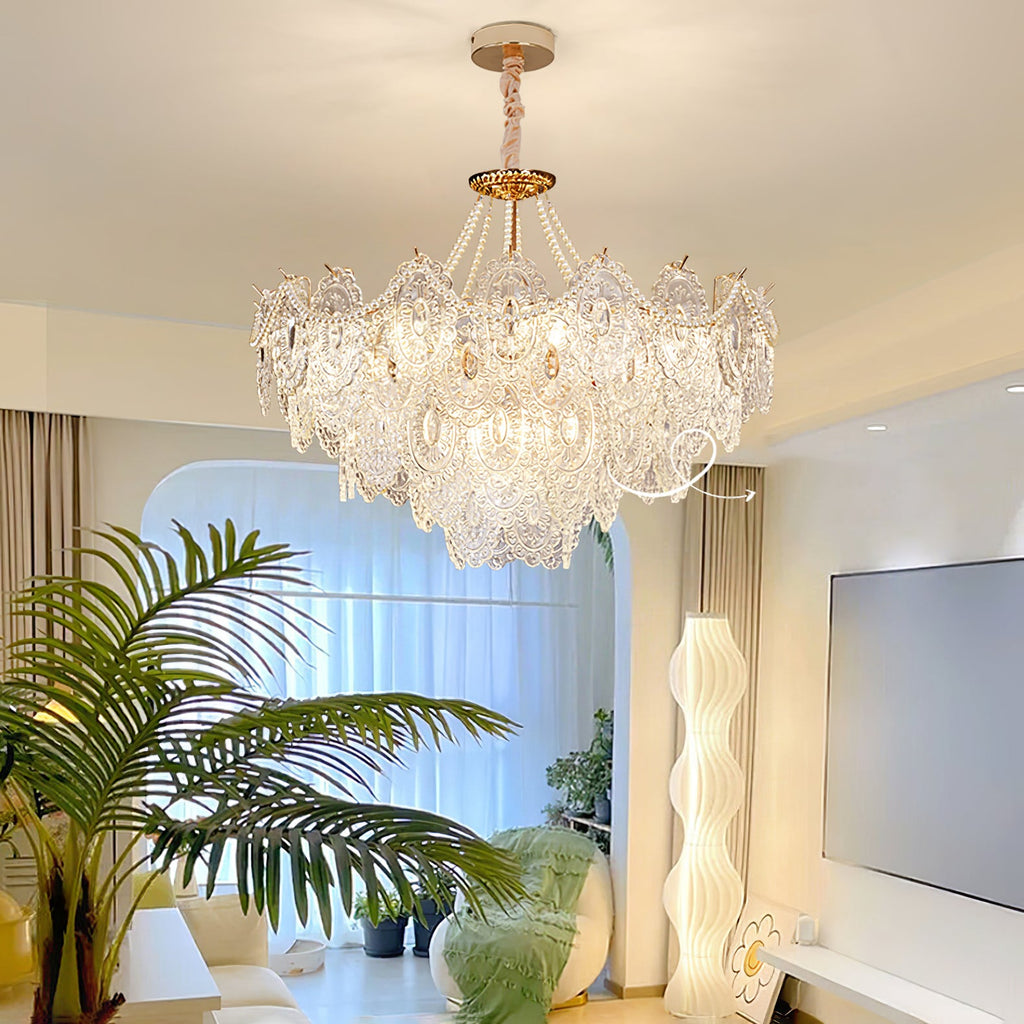 This Clérachic pendant light hangs in a bright living room with a large palm, a wavy white floor lamp and a wall-mounted screen.