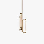 This Clérachic pendant on a plain white backdrop, three slim textured glass tubes on a brass frame hung from a single long brass rod.