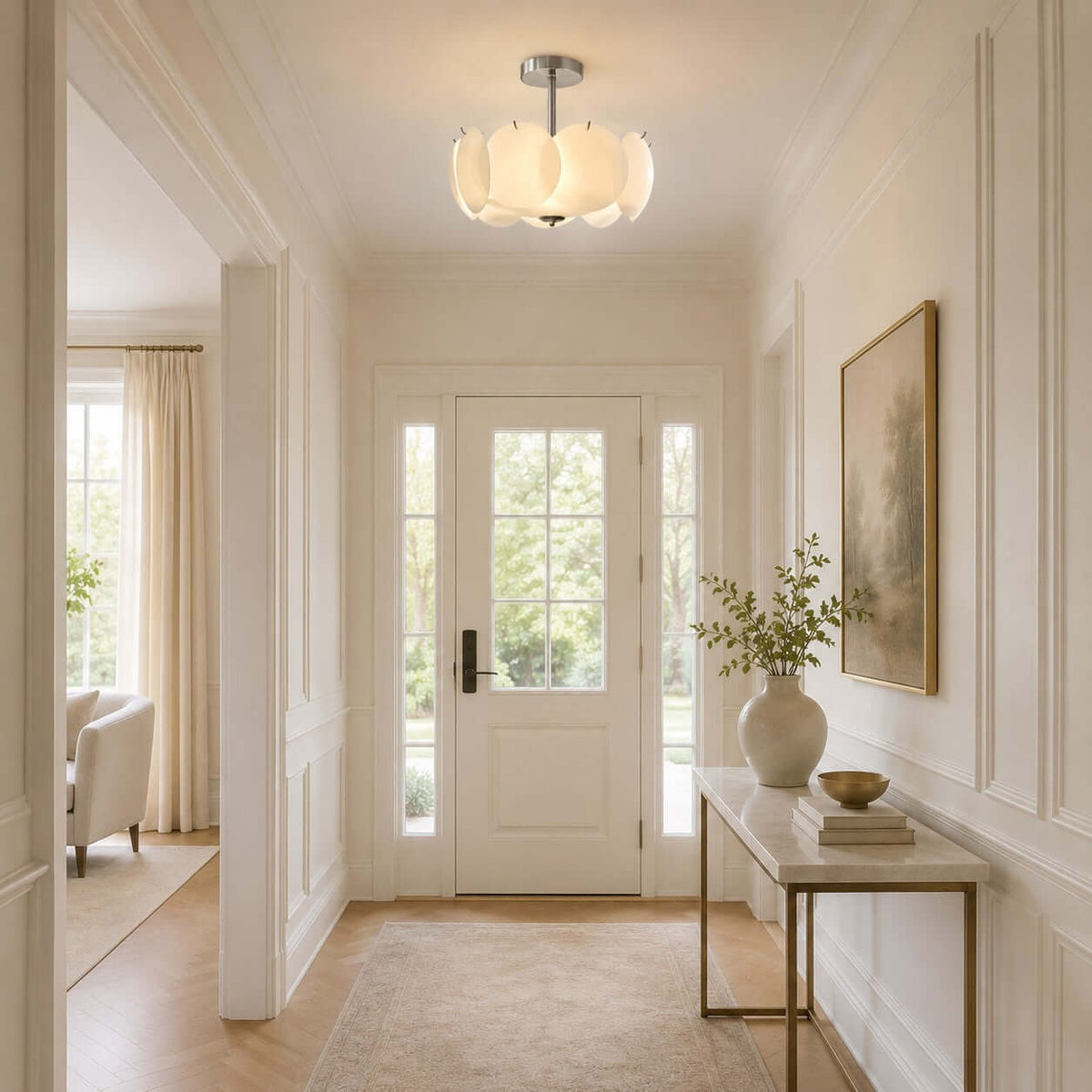 Clérachic glass-disc pendant lighting a hallway with a white front door, a console table and a framed landscape print.
