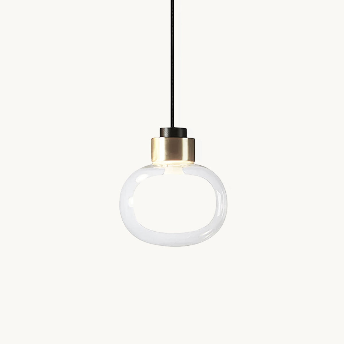 Clear glass pendant with a soft white inner glow and a gold-finish metal collar, shown on a plain white backdrop from Clérachic.