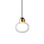 Clear glass pendant with a brass-toned collar and a glowing white inner globe, on a plain white backdrop, from Clérachic.
