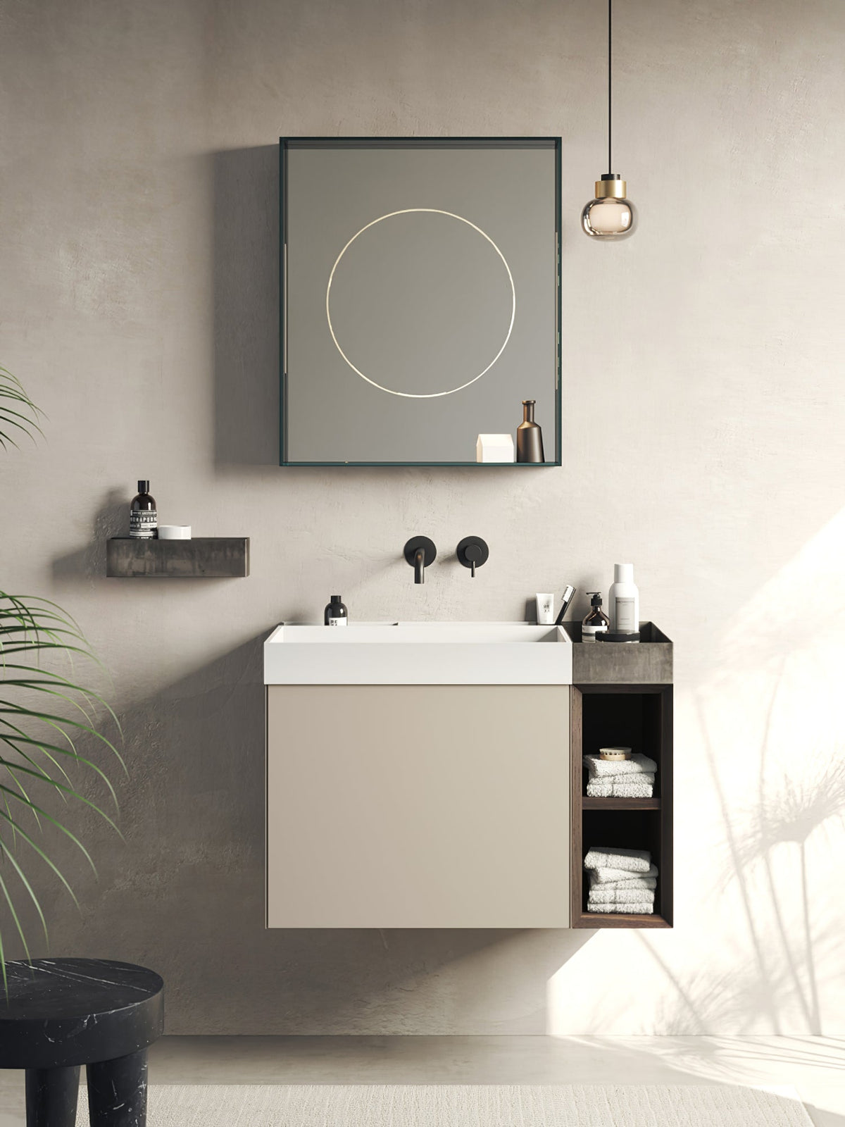 A Clérachic glass pendant hangs beside a wall-mounted bathroom vanity and a framed mirror with a thin circle of light.