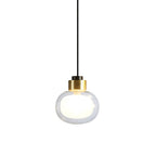 A Clérachic glass pendant with a brass-toned collar and a black cord, on a white backdrop, with a softly frosted inner glow.