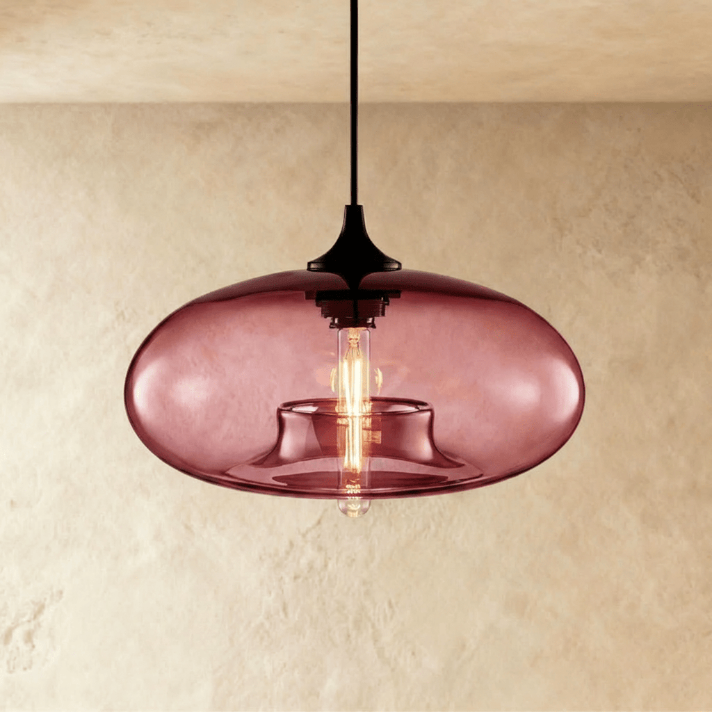 Clérachic pendant light with a dusky wine-red glass oval shade, black cord and cap, and a warm tube bulb glowing inside.
