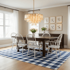 Over a dark wooden table with white spindle chairs, a Clérachic amber glass leaf pendant lights a beige dining room.