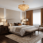 A Clérachic amber leaf-glass pendant hangs over a bed with a cream headboard, brown curtains and a bench at its foot.