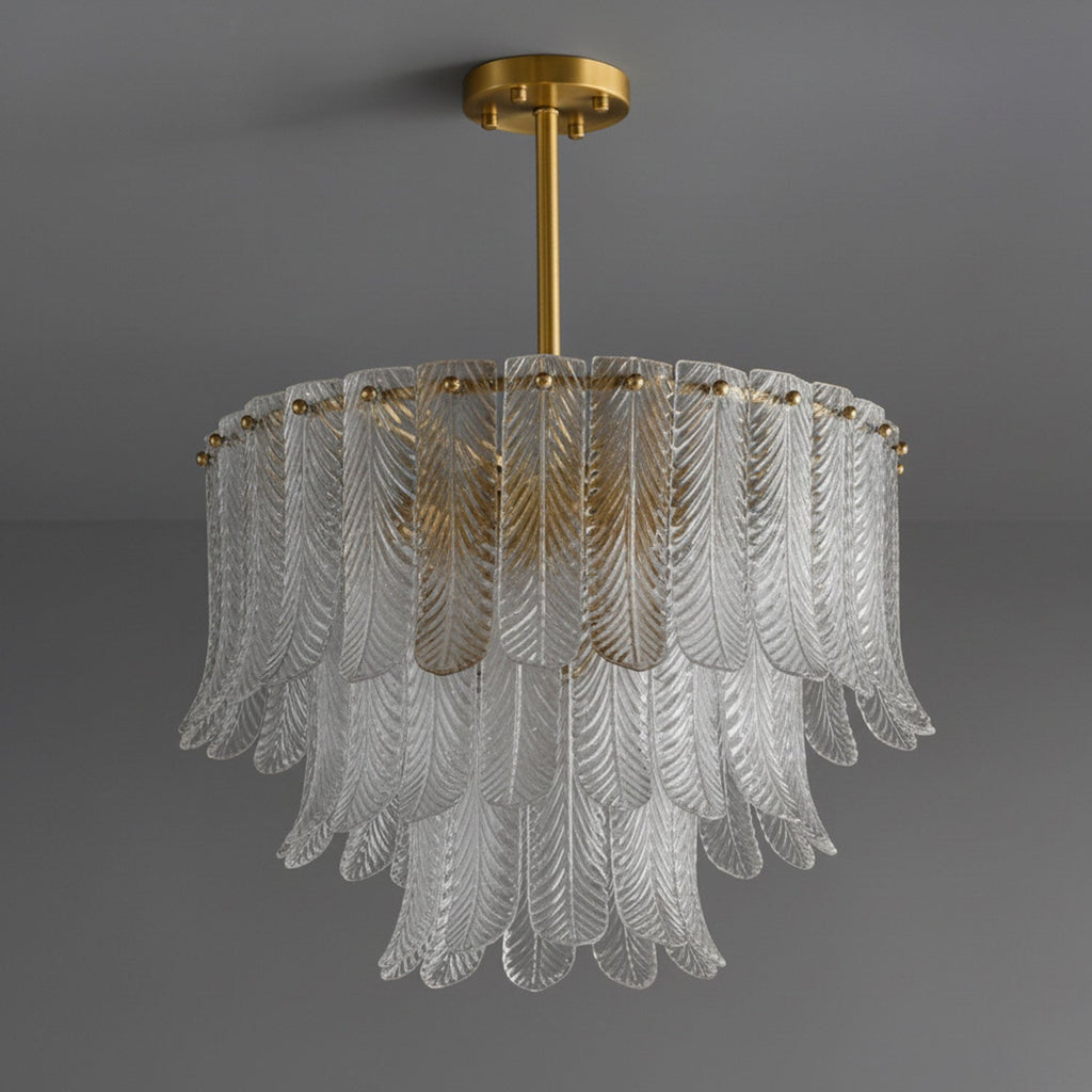 A Clérachic round pendant of clear ribbed glass leaves in three tiers, hung from a brass rod and canopy on dark grey.