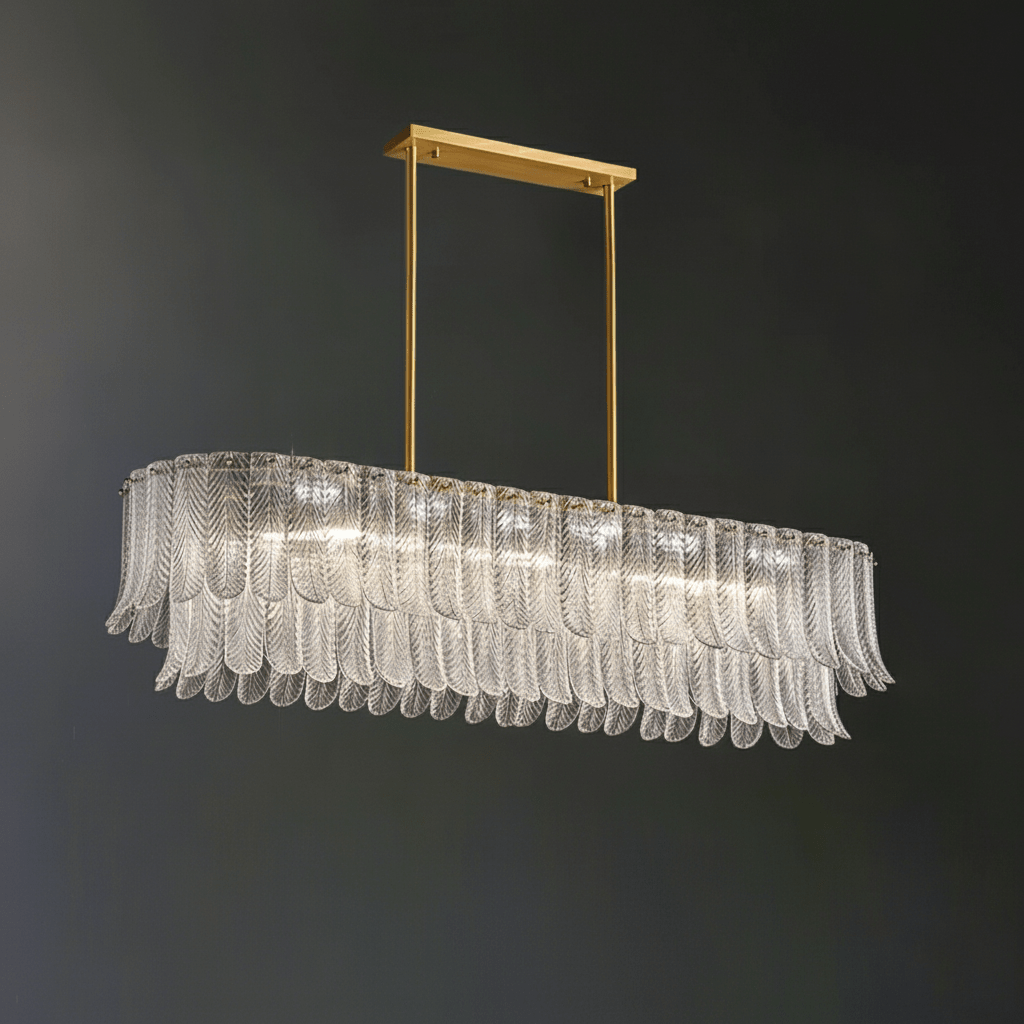 Clear glass leaves on a long oval frame make up this Clérachic linear pendant, hung from a brass bar on a dark grey wall.