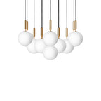 Wide Clérachic cluster of pendants with white opal globes on brass rods, shown unlit on a white background.