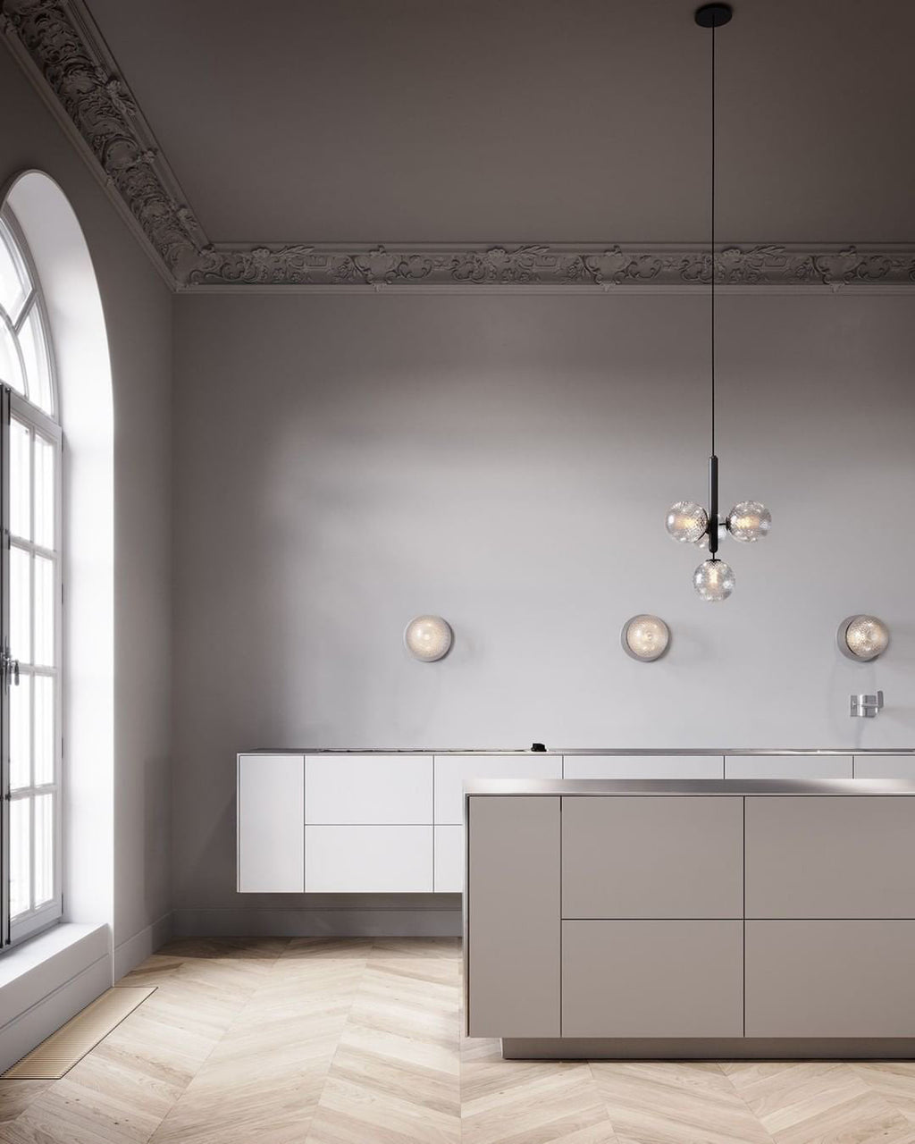 Clérachic glass cluster pendant hanging in a tall room with arched windows, a white kitchen island and wall lights.