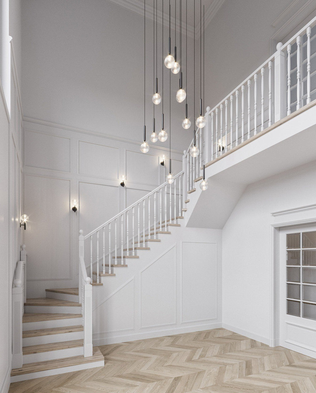 A cascade of Clérachic pendants with clear and opal globes hangs through a white stairwell with a wooden banister.