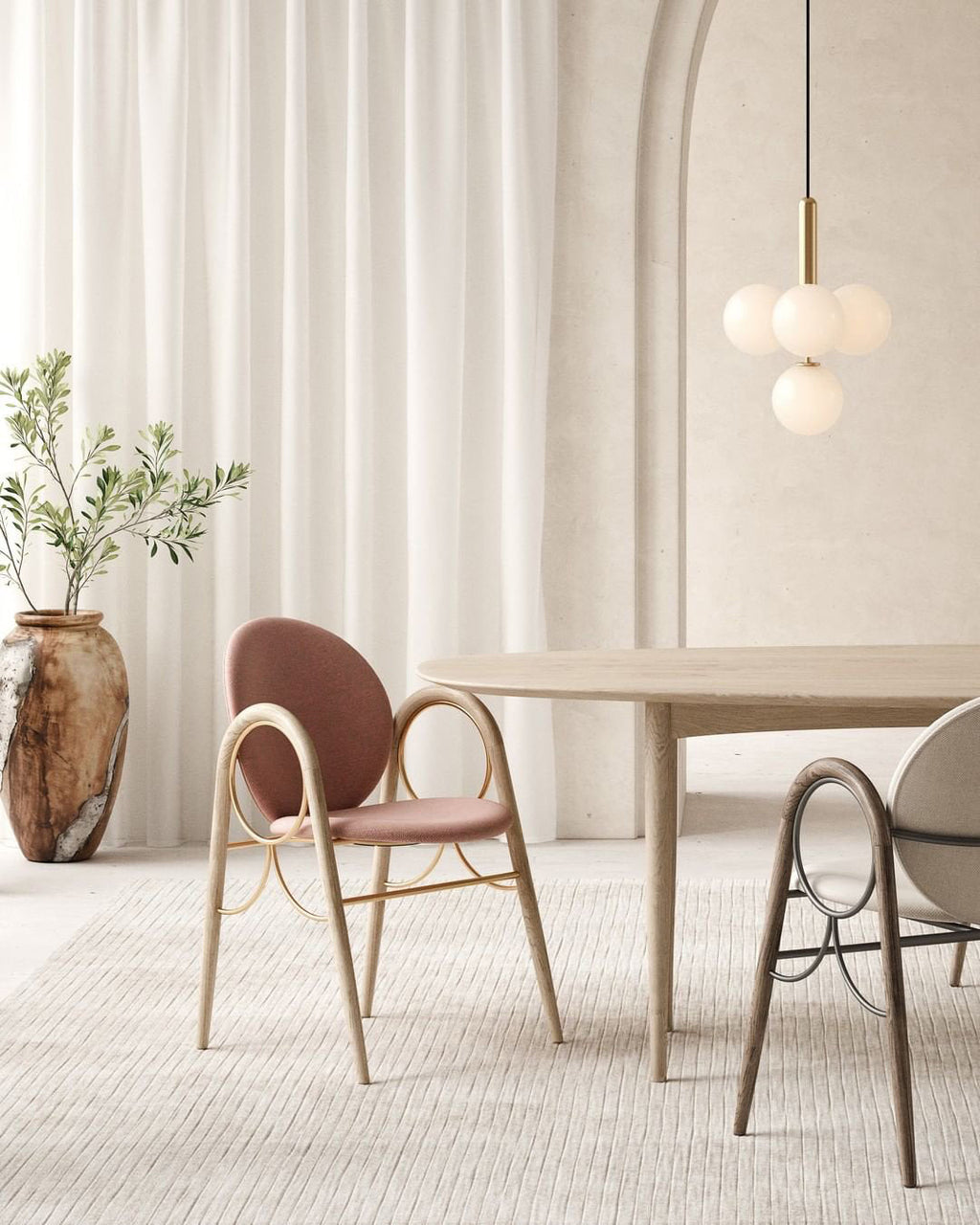 Brass-rod Clérachic pendant with white opal globes hangs above a pale wooden table against sheer cream curtains.