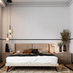Three Clérachic pendants with white globes hang at staggered heights above a bed in a pale room.