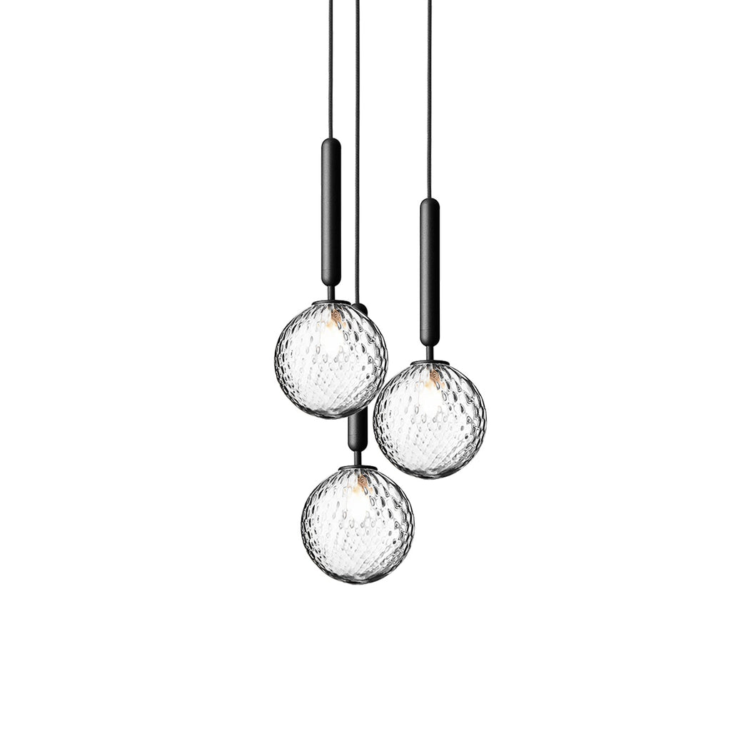 Three Clérachic pendants with clear textured globes on black rods, shown at different heights on white.